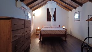 Une chambre à coucher avec un plafond en bois, un lit à baldaquin, une commode, des lampes de chevet et une fenêtre.
