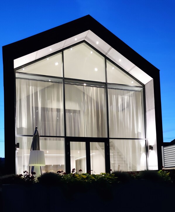 A modern building with large glass windows and a black exterior. - Maison D'Architecte in one of France's most beautiful villages (Bergheim)