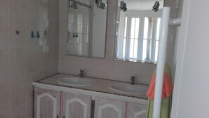 A bathroom with two sinks, a mirror, and a towel rack. - LARGE COUNTRY HOUSE in the South Luberon (Cabrières d Aigues)