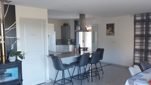 A compact living space with a kitchenette, a dining area, and a seating area with a table and chairs. - 110 m² villa with a pool and breathtaking views, not overlooked. (La Motte)