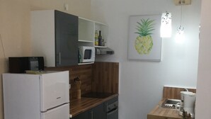 A compact kitchen with a refrigerator, microwave, and wooden countertop. - PRVINSKI AKVAREL, large renovated fisherman's house adapted for disabled visitors  (Prvić Luka)