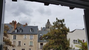 A view of historic buildings with multiple windows and a prominent church tower. - In the heart of the city center (Blois)