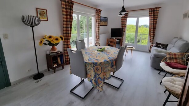A dining area with a table, chairs, a TV, and a sofa. - Country house with wonderful view over the Lot valley (Galapian)