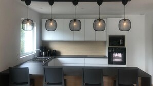 A modern kitchen with a central island, bar stools, and pendant lighting. - Villa with pool between the Côte d'Azur and the Gorges du Verdon (8 people) (Callas)