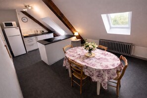 Een kleine keuken met een eethoek.