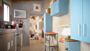 A kitchen with blue cabinets, a white countertop, and a hanging pot rack. - IDEAL COZY HOUSE FOR 1 COUPLE AND 2 CHILDREN  (Sainte-Marie-de-Ré)