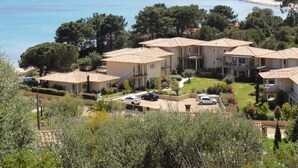 A coastal residential area with terraced houses, a beach, and a clear view of the sea.
