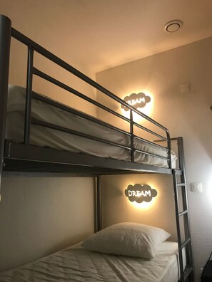 A bunk bed with a 'DREAM' sign above it, a ladder, and a white pillow on the lower bunk. - Pied du télécabine. T2 + alcove. Parking couvert. (Cauterets)