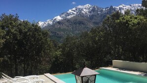 A swimming pool with lounge chairs and a mountain backdrop. - SUPERB RENT ANY COMFORT - POOL - BOULODROME - PRIVATE PARKING IN PEACE (Calenzana)