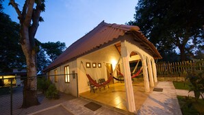 A house with a tiled roof and a hammock. - A third world oasis on the idyllic beach of Santa Clara. (Santa Clara)
