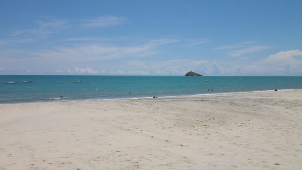 A wide sandy beach with calm waters and a small island in the distance. - A third world oasis on the idyllic beach of Santa Clara. (Santa Clara)