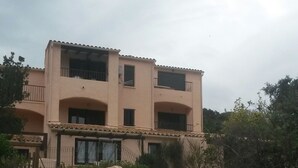Un edificio de varios pisos con una escalera que lleva a la entrada.
