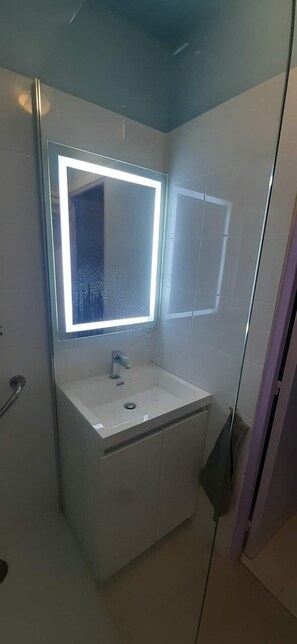Shower, hair dryer, towels, toilet paper