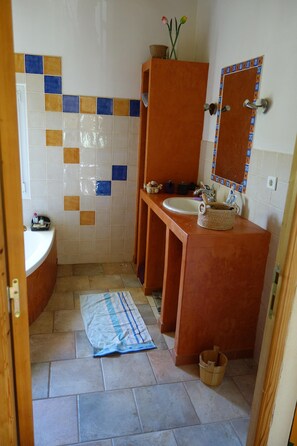 Bathroom features a sink, mirror, and tiled backsplash.