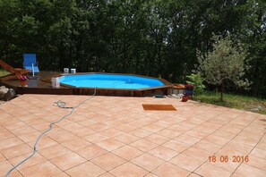 Relax by the pool surrounded by a deck and outdoor seating.