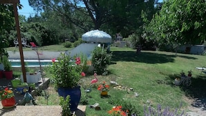 A garden with various potted plants and a small fountain.