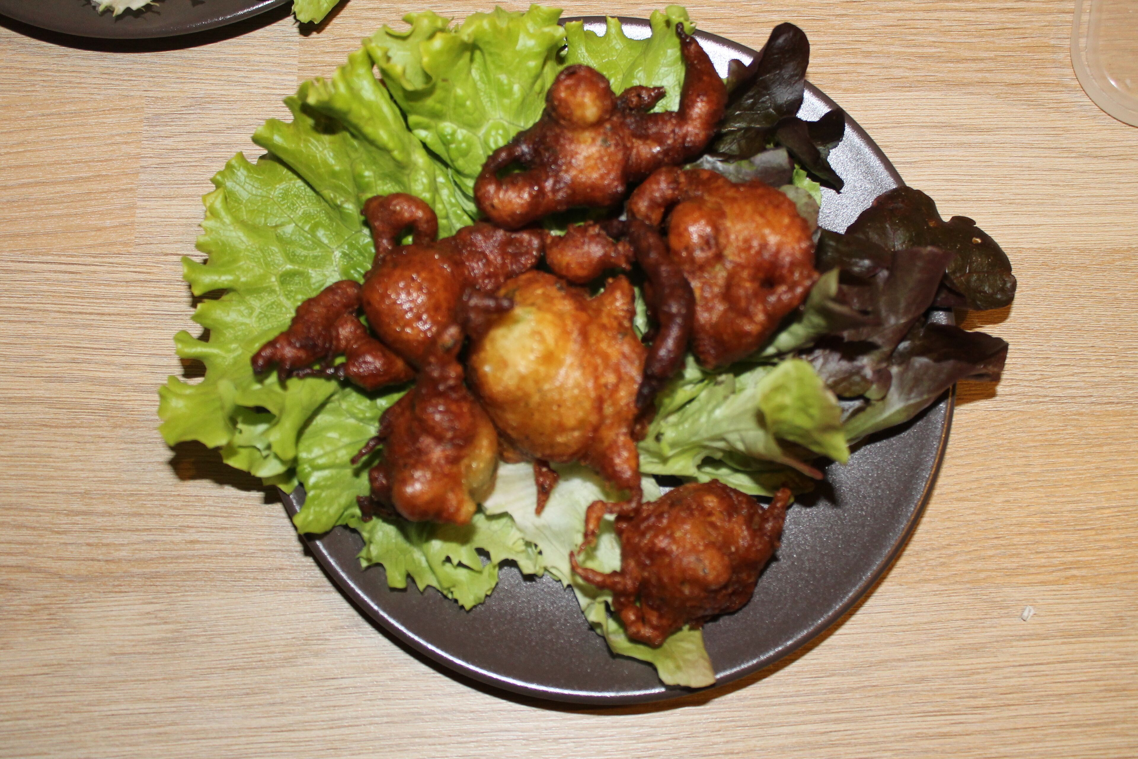A plate of fried chicken with vegetables on a table.
