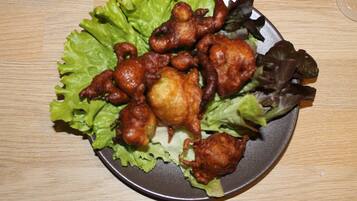 A plate of fried chicken with vegetables on a table.