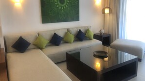 A modern living room with a sofa, a coffee table, and a Buddha statue. - Aldea Thai Penthouse  2br big private roof top & private pool by oceanfront  (Playa del Carmen)