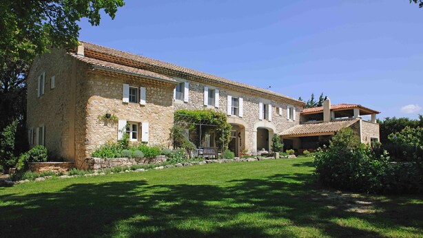 A stone building with a tiled roof, multiple windows, and a well-maintained lawn. - Beautiful  countryhouse in rural surroundings with pool and pool house.   (Grignan (Drome Provencale))