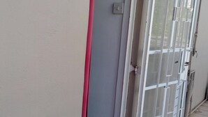 A building entrance with a sliding glass door and a red mat at the threshold. - Airconditioned room wit kitchnette ideal for individual, family and groups. (Grand Bay)