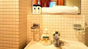A bathroom with a sink, mirror, and toiletries. - CHALET AU SWISS style (Zürich)