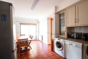 Compact kitchen with appliances, dining area, and modern amenities.