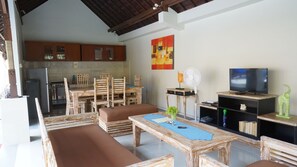 Cozy living area with a dining set, television, and kitchenette.