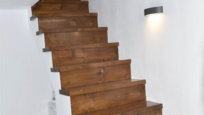 A wooden staircase with a modern design, white walls, and a tiled floor. - Large Villa for nine people (Skopelos Town, Skopelos Island)