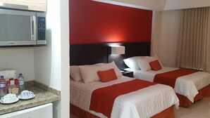 A hotel room with two beds, a minibar, and a microwave. - Bahia Escondida, excelentes vacaciones en un paraiso!! (Santiago)