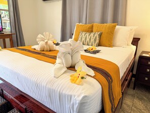 A hotel room with a neatly made bed, a wooden nightstand, and a window with curtains. - Luxury Bed And Breakfast With Pool  (Hopkins)