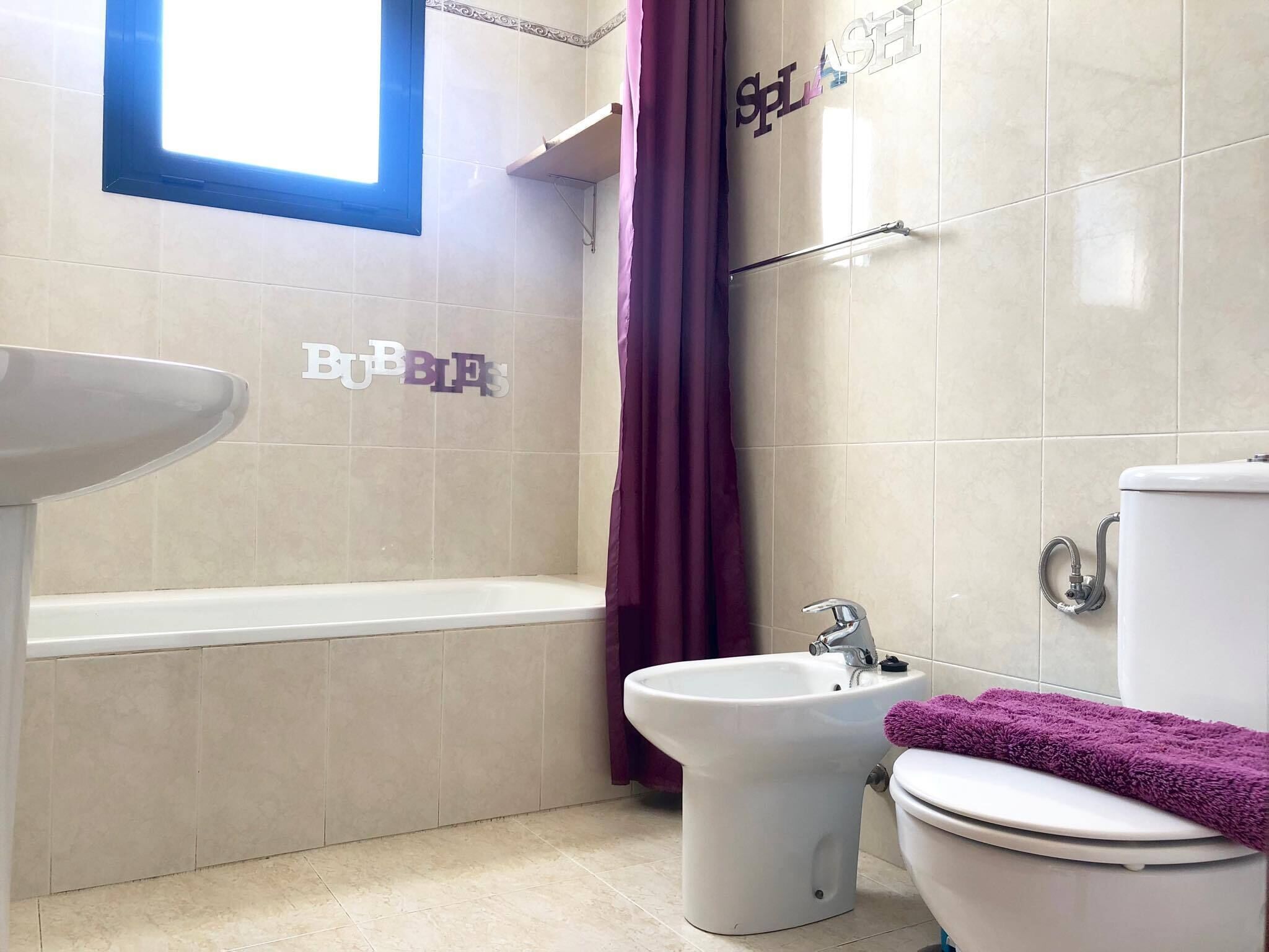 A bathroom with a bathtub, a bidet, and a toilet.