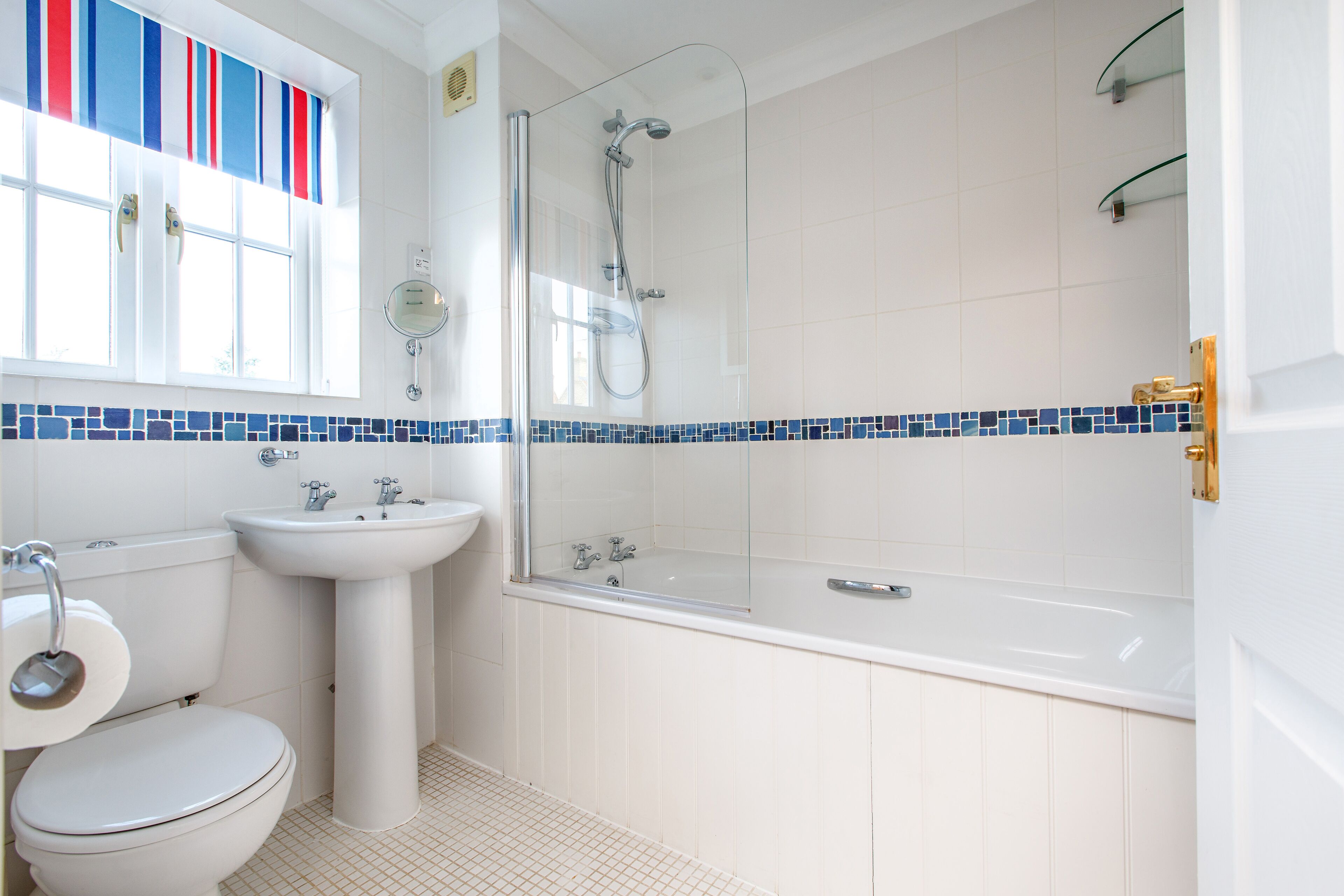 A bathroom with a toilet, sink, shower, and bathtub.