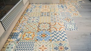 A floor with a variety of colorful, patterned tiles. - DB Nice Apartment Sagrada Familia (Barcelona)