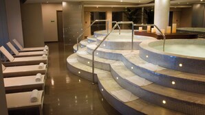 A spa area with a hot tub, seating area, and steps leading to the tub. - 24o Penthouse Unique Design 2 Balconies Oceanview (Panama City)