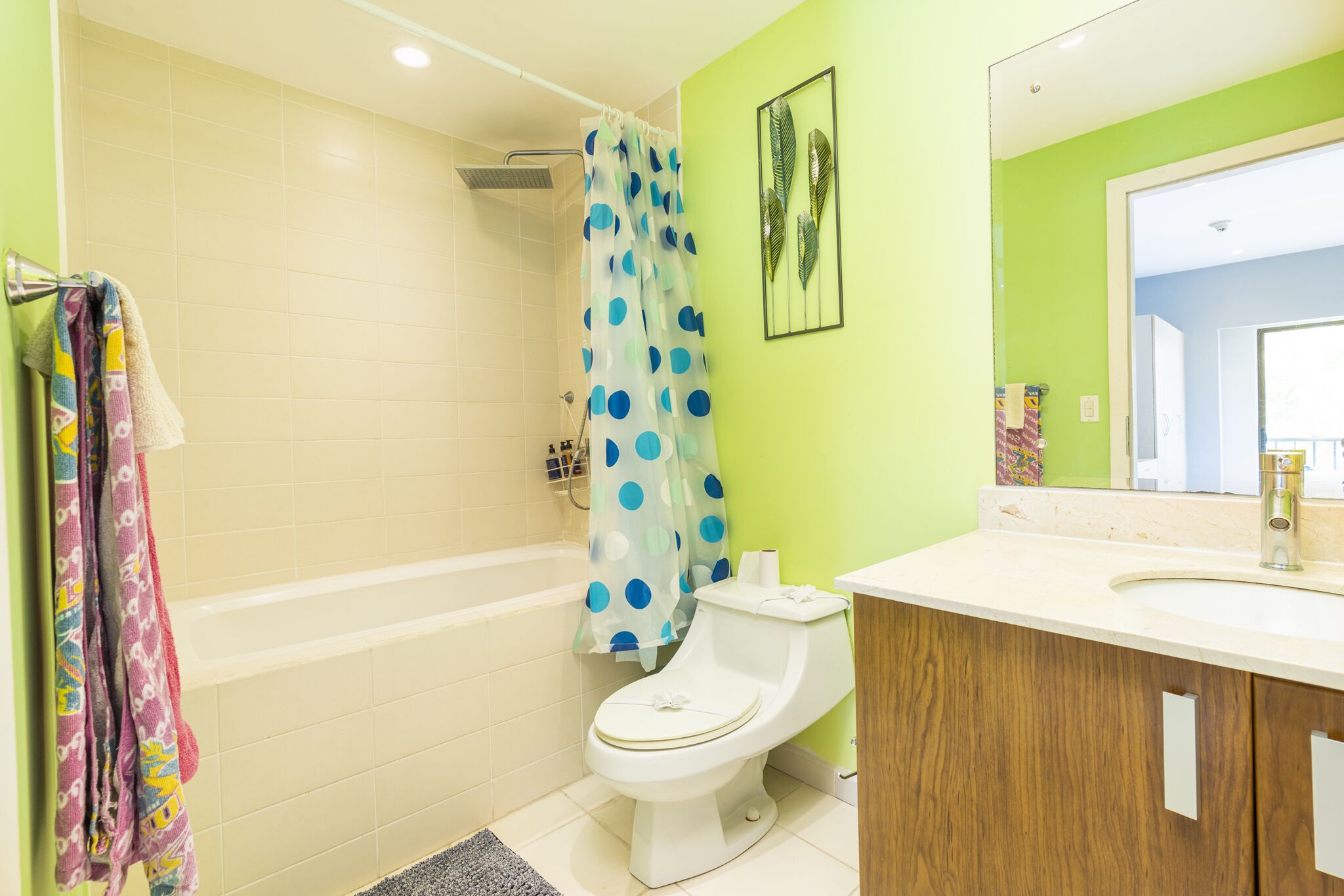 A bathroom with a bathtub, toilet, and sink.