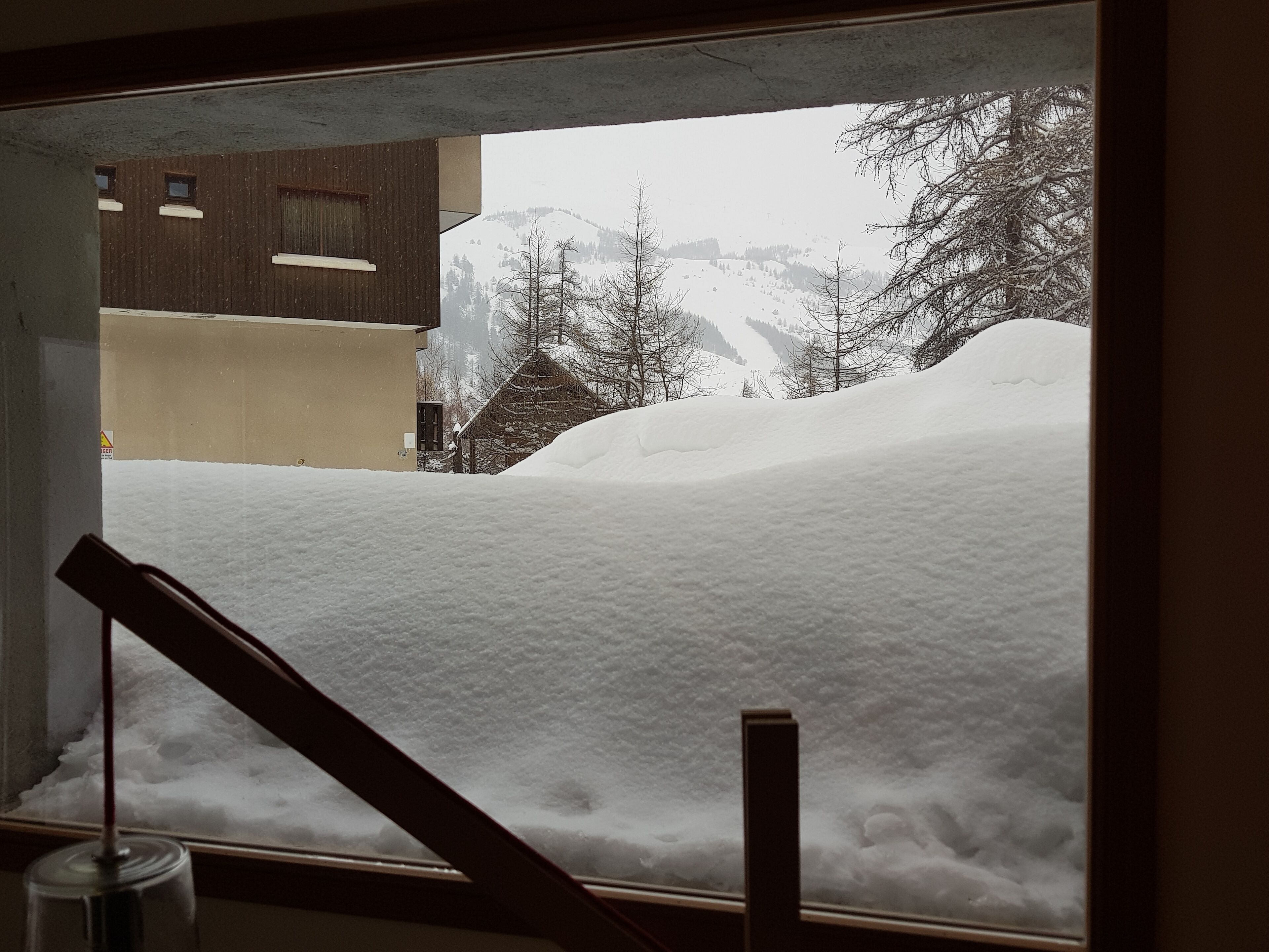 A snowy landscape with a building in the background.