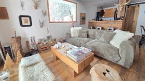 A cozy living room with a sectional sofa, wooden coffee table, and a fireplace. - Vars. Full-service center.  Private parking. Linens provided, beds made. (Vars)