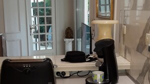 A modern kitchen with a stainless steel sink, a coffee maker, and a black bag on the counter. - Residential area 5 minutes from the beach  (Cannes)