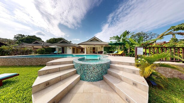 A resort with a swimming pool, a hot tub, and a covered seating area with umbrellas. - Junior Pool Villa in Beach resort (Ko Samui)