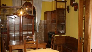 A traditional dining room with a wooden table, chairs, and a hanging light fixture. - Looking for a quiet place? VILLA CASCIANI (Diecimo)