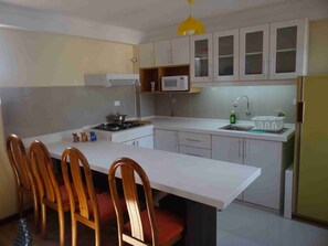 Fridge, microwave, coffee/tea maker, cookware/dishes/utensils