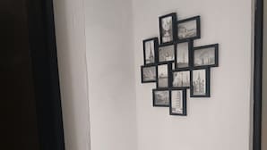 A hallway with a wall-mounted photo collage.