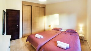A hotel room with a large bed, a wardrobe, and a desk with a lamp. - 2 BDR with Balcony ► Best Location: German Colony - Shelter in the building (Jerusalem)
