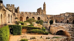 An ancient stone fortress with arched walkways and a prominent tower. - 2 BDR with Balcony ► Best Location: German Colony - Shelter in the building (Jerusalem)