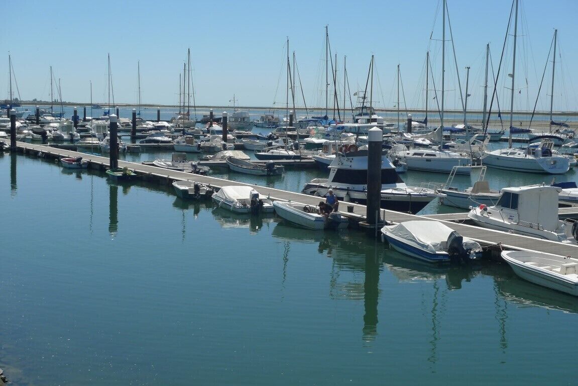 A marina with numerous boats docked at the pier.