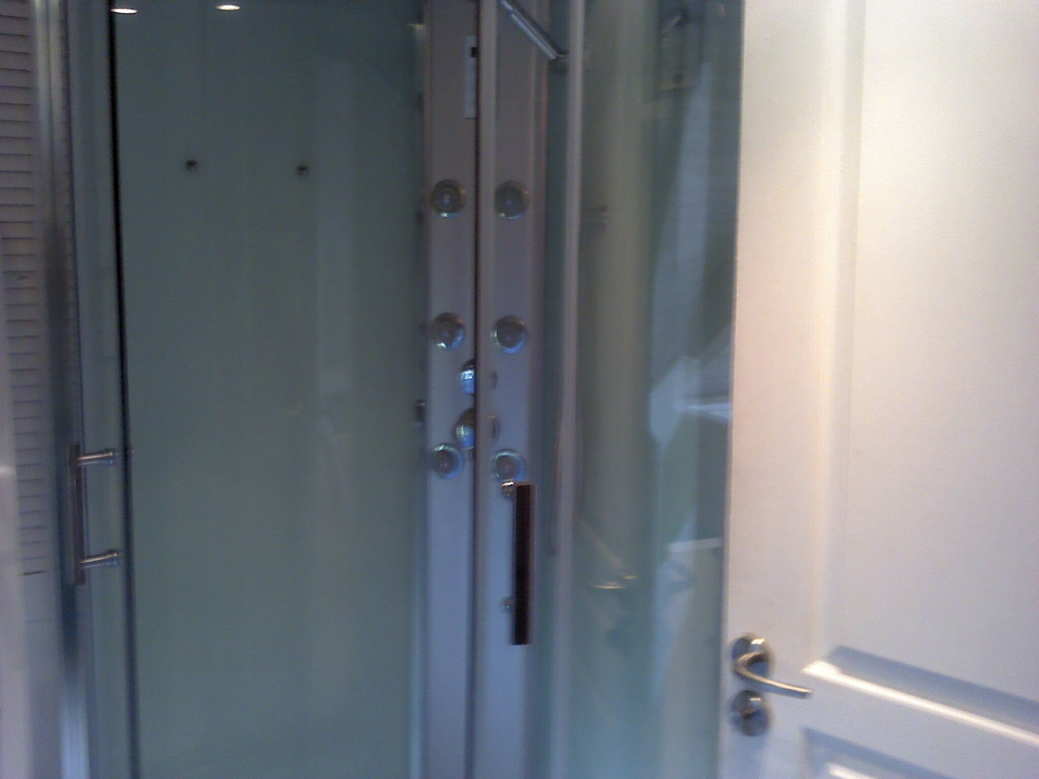 A glass door with a metallic handle and a keyhole.