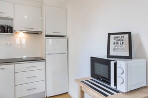 Fridge, microwave, stovetop, cookware/dishes/utensils