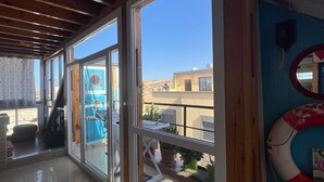 A spacious room with large sliding glass doors leading to a balcony. - Charming 2 bedroom  Penthouse with nautical decor (Aradir Provence)