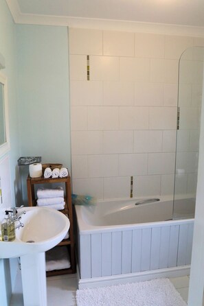 Combined shower/tub, hair dryer, towels, toilet paper